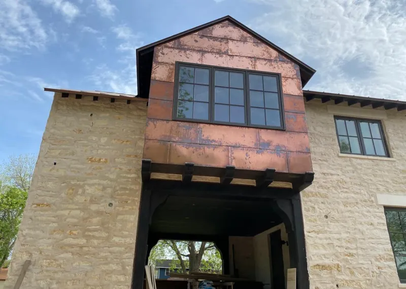 Copper metal panel facade on a stone building for Roof Repair in Manteca