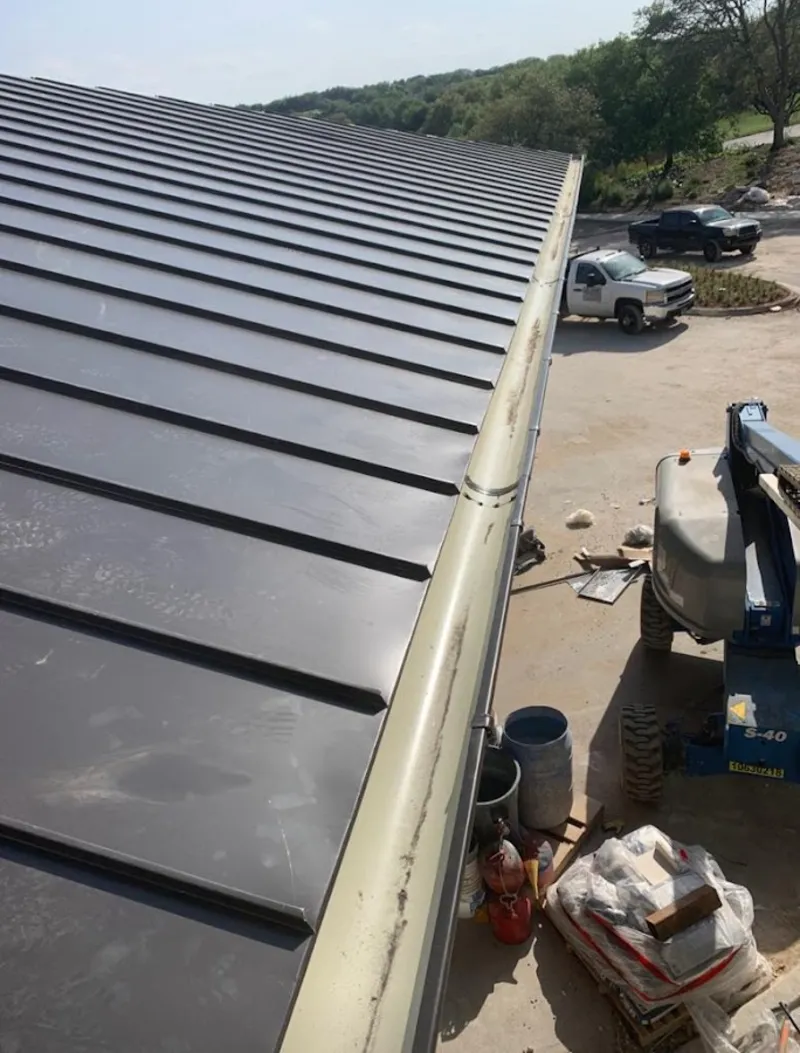 Standing seam panel and gutter detail on a metal roofing jobsite in Manteca